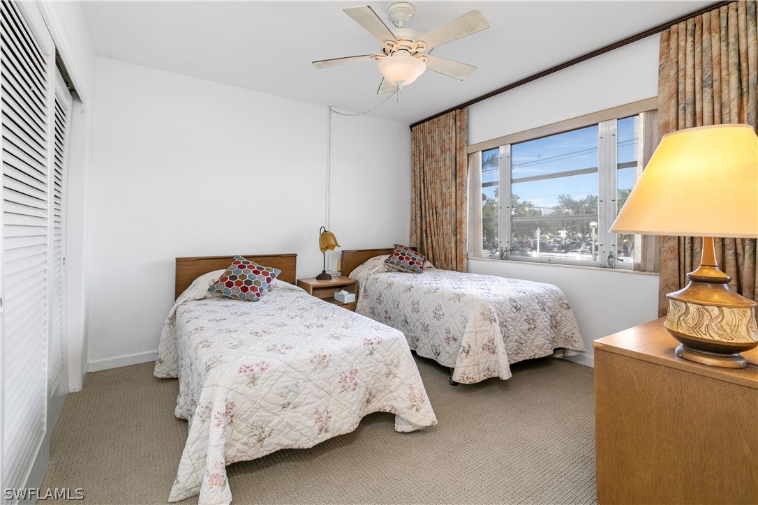 2544 First Street, Unit 201 Fort Myers, FL 33901 - Photo 12 of 19 a bedroom with two beds and a chandelier