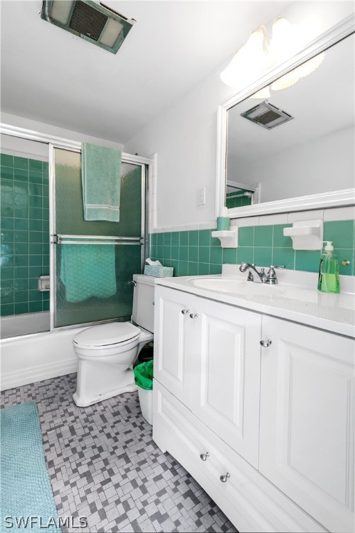 2544 First Street, Unit 201 Fort Myers, FL 33901 - Photo 13 of 19 a bathroom with a sink a toilet and a mirror