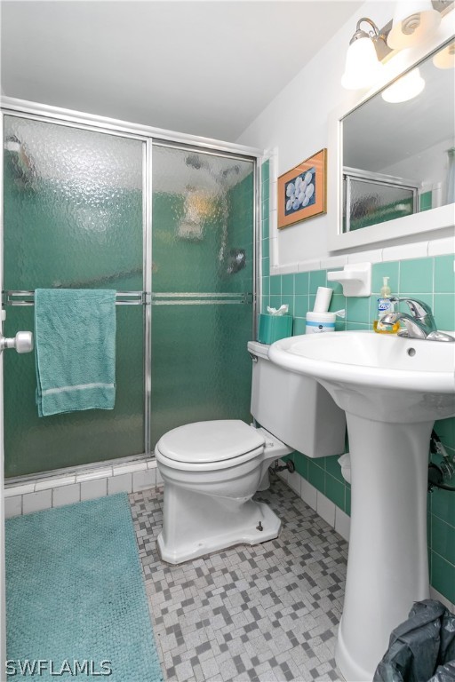 2544 First Street, Unit 201 Fort Myers, FL 33901 - Photo 15 of 19 a bathroom with a sink a toilet and a mirror