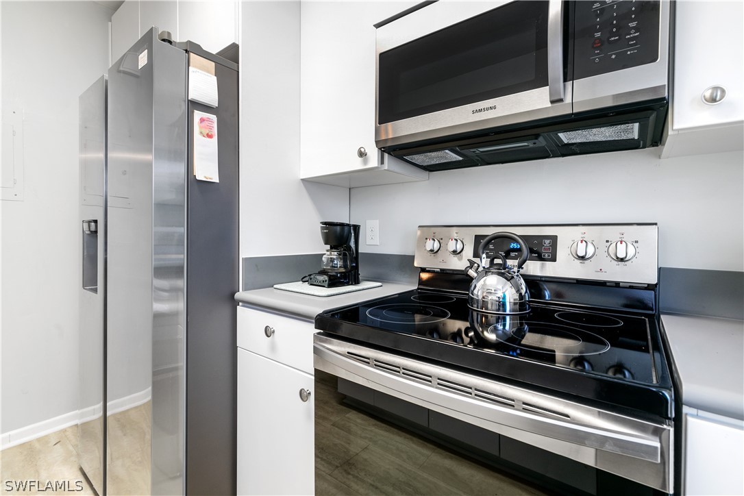 2544 First Street, Unit 201 Fort Myers, FL 33901 - Photo 5 of 19 a kitchen with a stove and a microwave