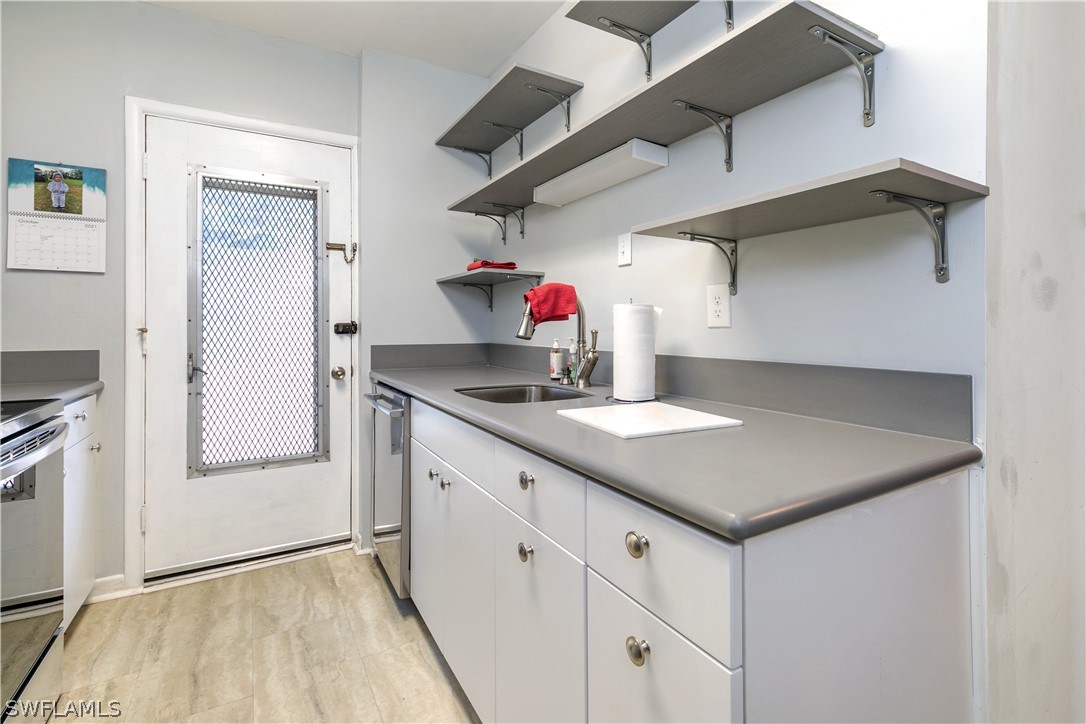2544 First Street, Unit 201 Fort Myers, FL 33901 - Photo 6 of 19 a kitchen with cabinets and wooden floor