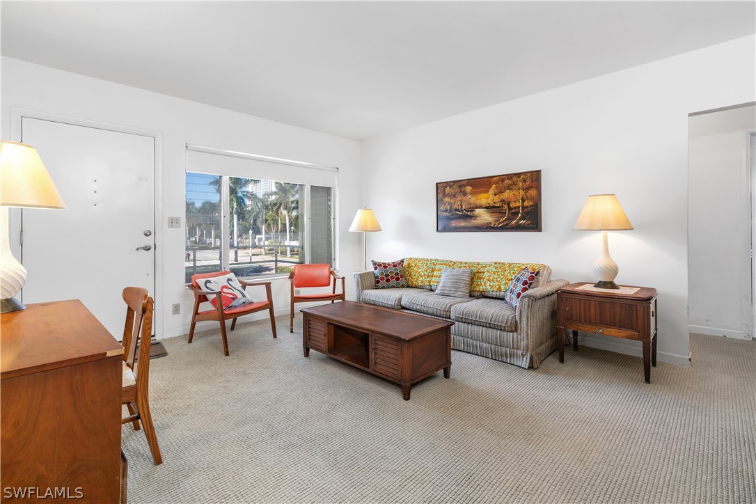 2544 First Street, Unit 201 Fort Myers, FL 33901 - Photo 8 of 19 a living room with furniture and a lamp