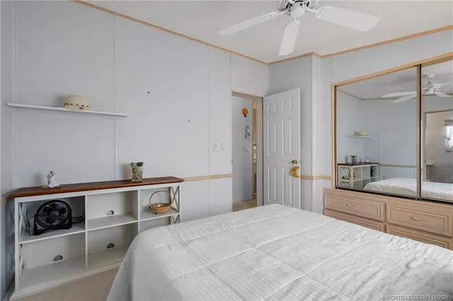 a bedroom with a bed and a large mirror