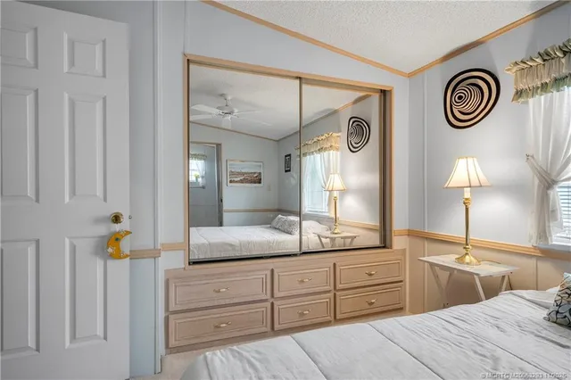 a spacious bathroom with a granite countertop sink and a mirror