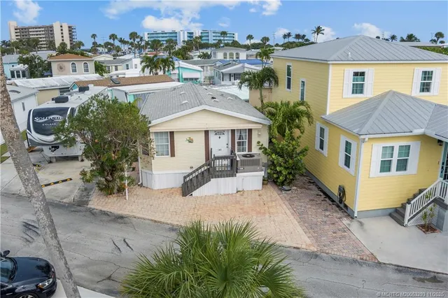 a view of a house with a yard and sitting area