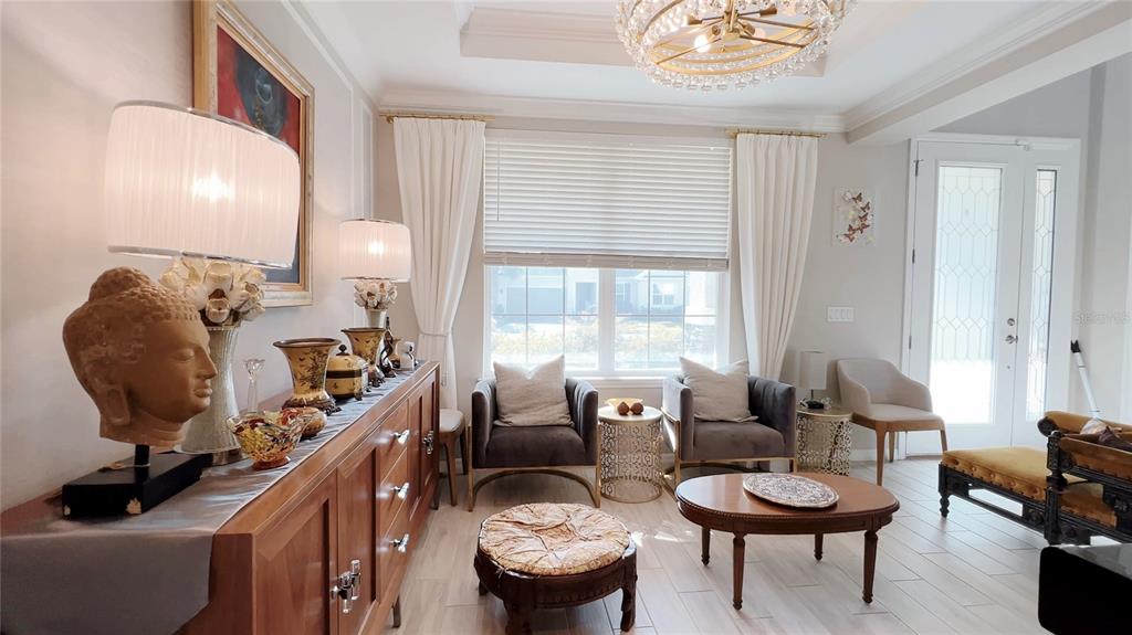 3383 Current Avenue Clermont, FL 34711 - Photo 13 of 53 a living room with furniture and a large mirror