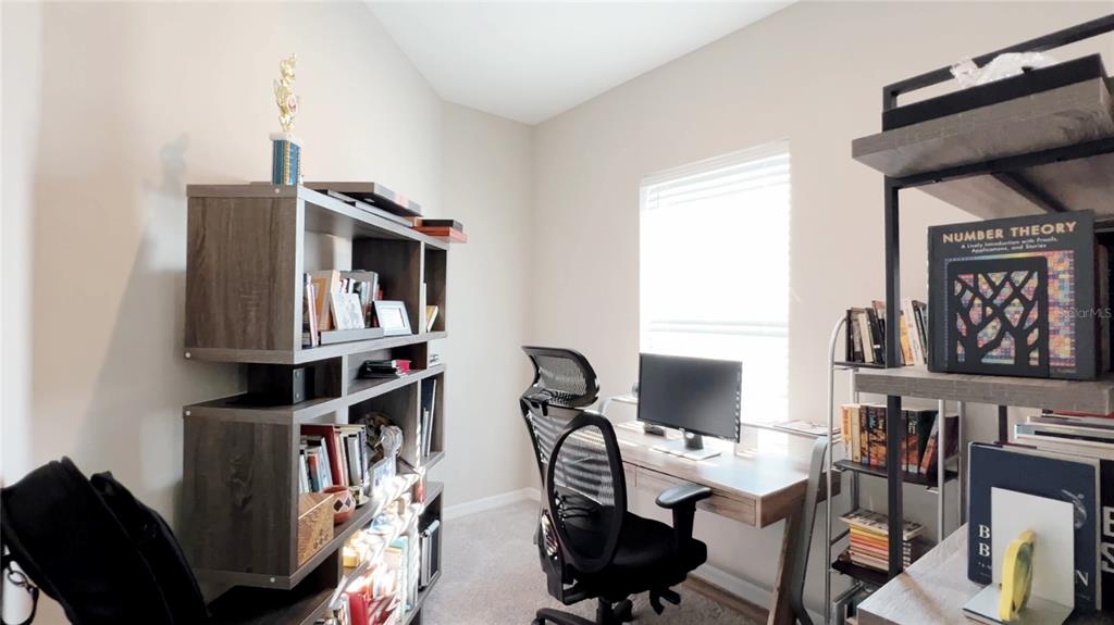 3383 Current Avenue Clermont, FL 34711 - Photo 26 of 53 a view of a workspace with furniture and a window