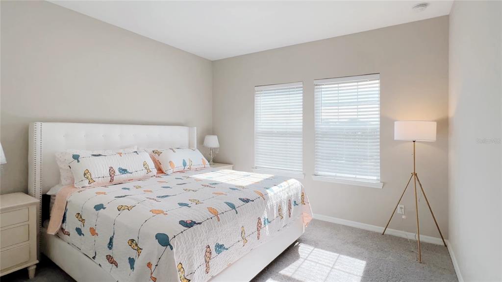 3383 Current Avenue Clermont, FL 34711 - Photo 31 of 53 a bedroom with a bed and a window