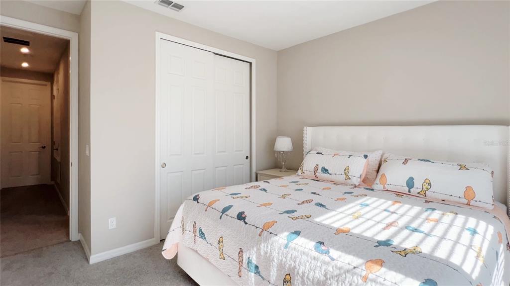 3383 Current Avenue Clermont, FL 34711 - Photo 32 of 53 a bedroom with a bed and a mirror