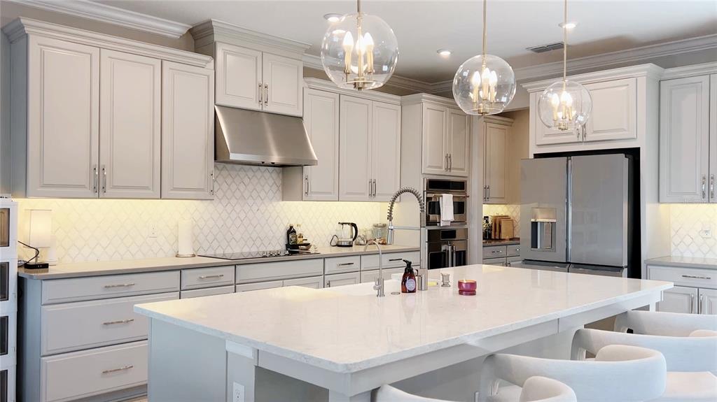 3383 Current Avenue Clermont, FL 34711 - Photo 9 of 53 a kitchen with a sink a counter space cabinets and stainless steel appliances