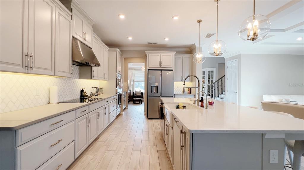 3383 Current Avenue Clermont, FL 34711 - Photo 10 of 53 a kitchen with kitchen island a sink appliances and cabinets