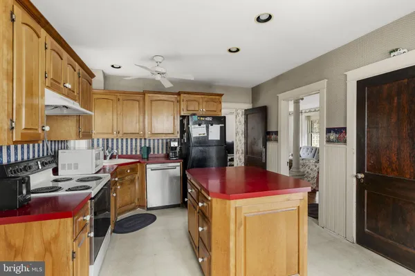 a kitchen with a table chairs and refrigerator