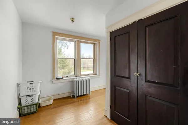 a view of an entryway with wooden floor and a livingroom