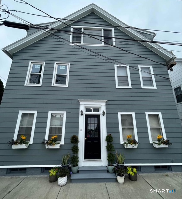 a front view of a house with a large window