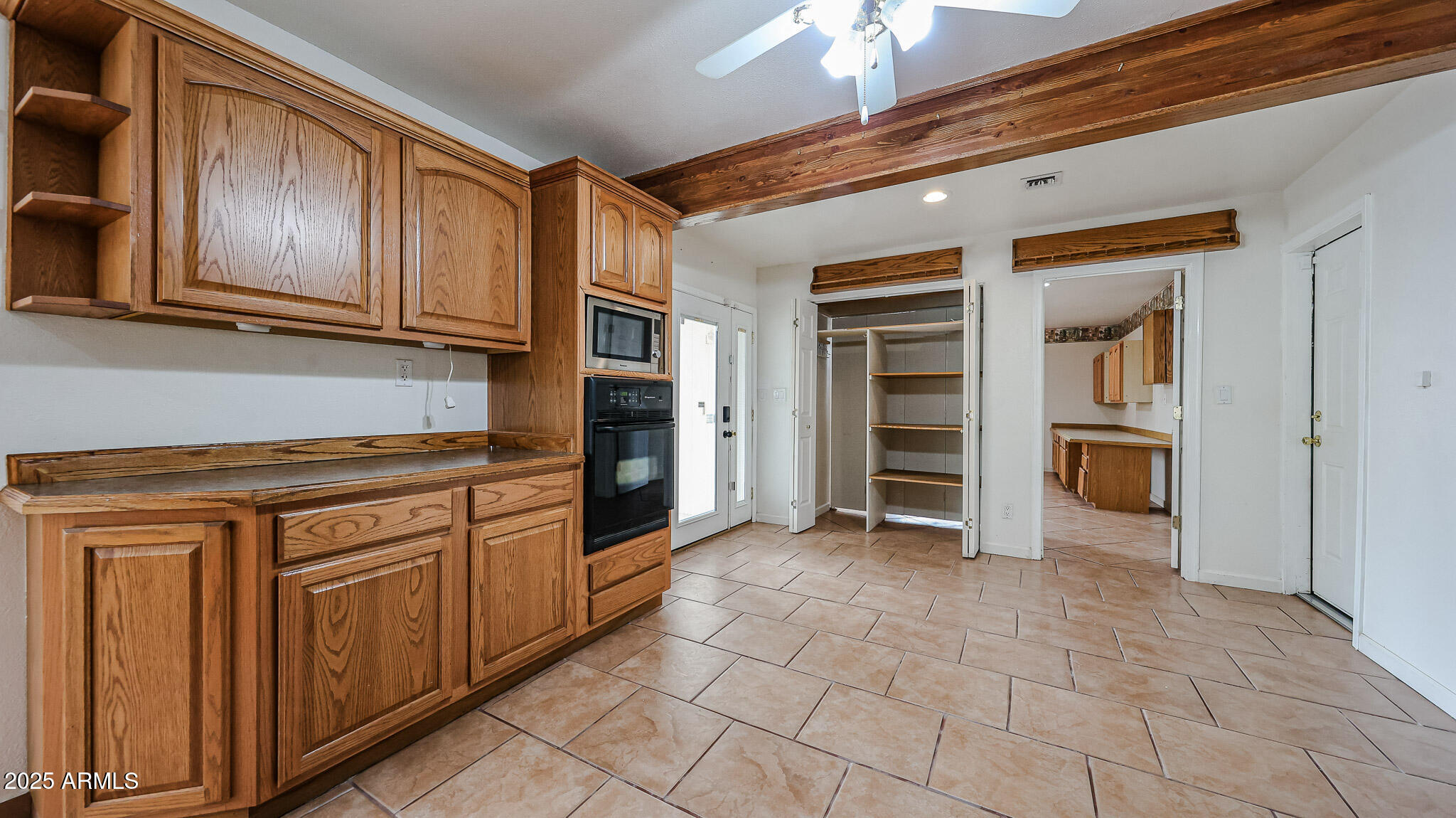 11851 North Thunderbird Road Sun City, AZ 85351 - Photo 15 of 46 a kitchen with stainless steel appliances granite countertop a refrigerator and cabinets