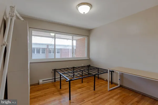 a room with wooden floor and a window