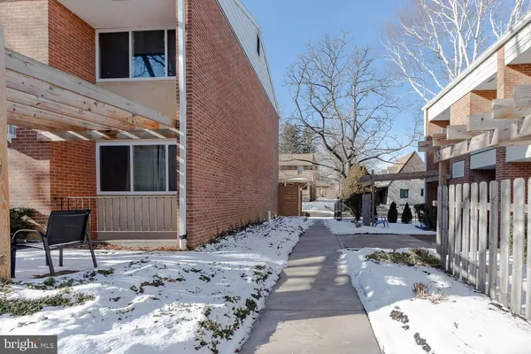 a backyard of a house with barbeque oven and wooden fence
