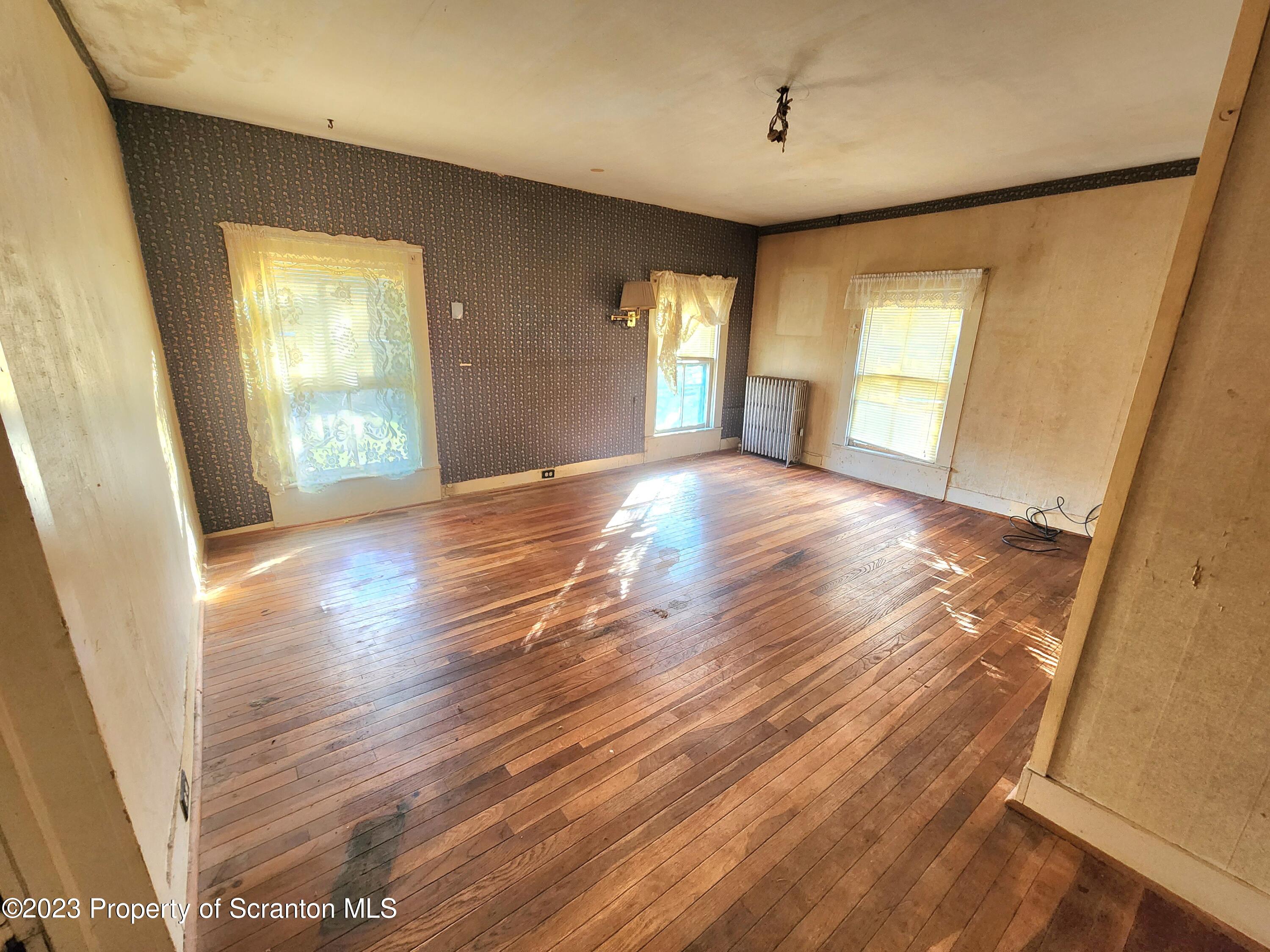 21 High Street Nicholson, PA 18446 - Photo 16 of 33 a view of livingroom with hardwood floor and window