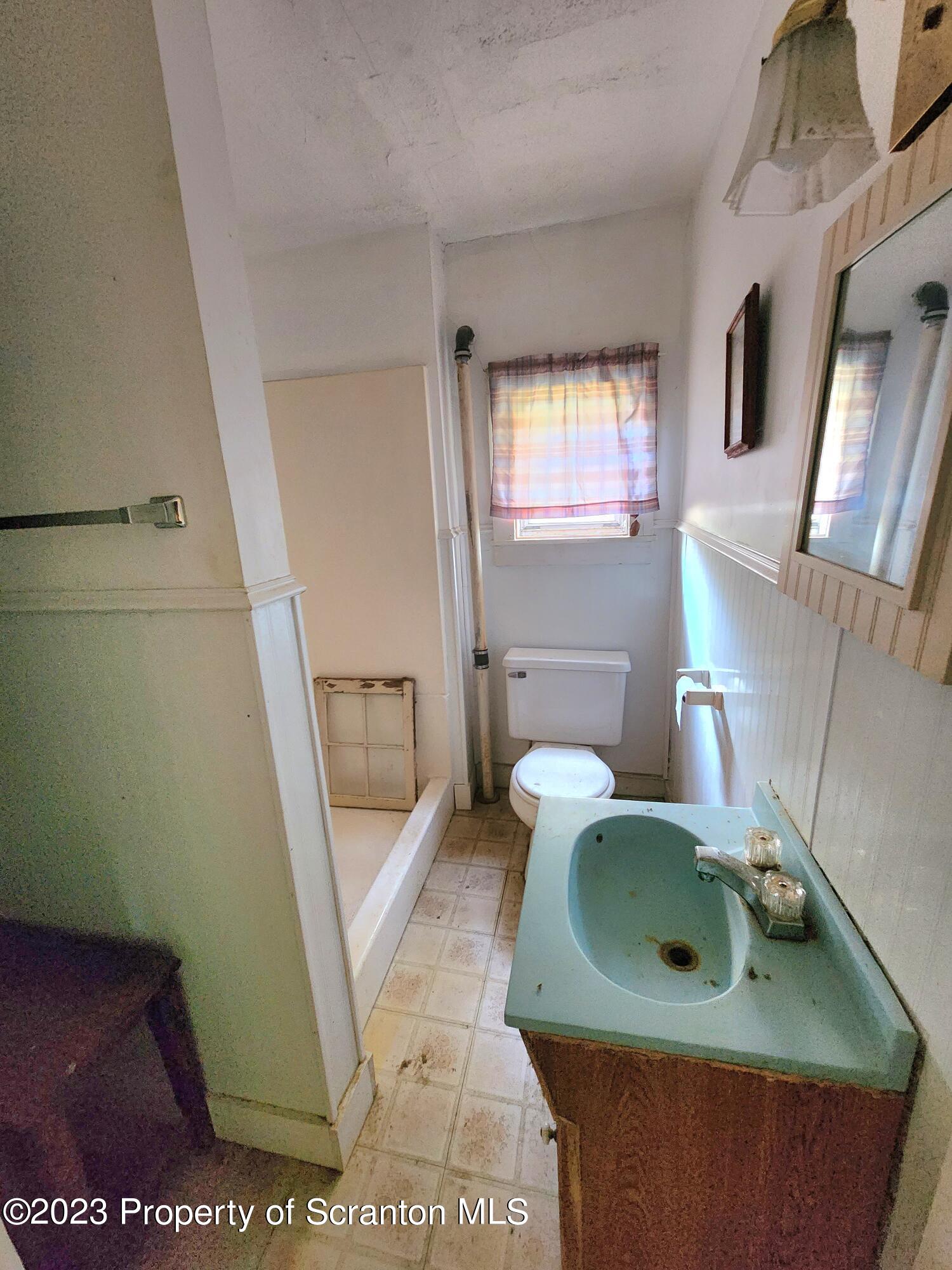 21 High Street Nicholson, PA 18446 - Photo 23 of 33 a bathroom with a sink a toilet and a mirror