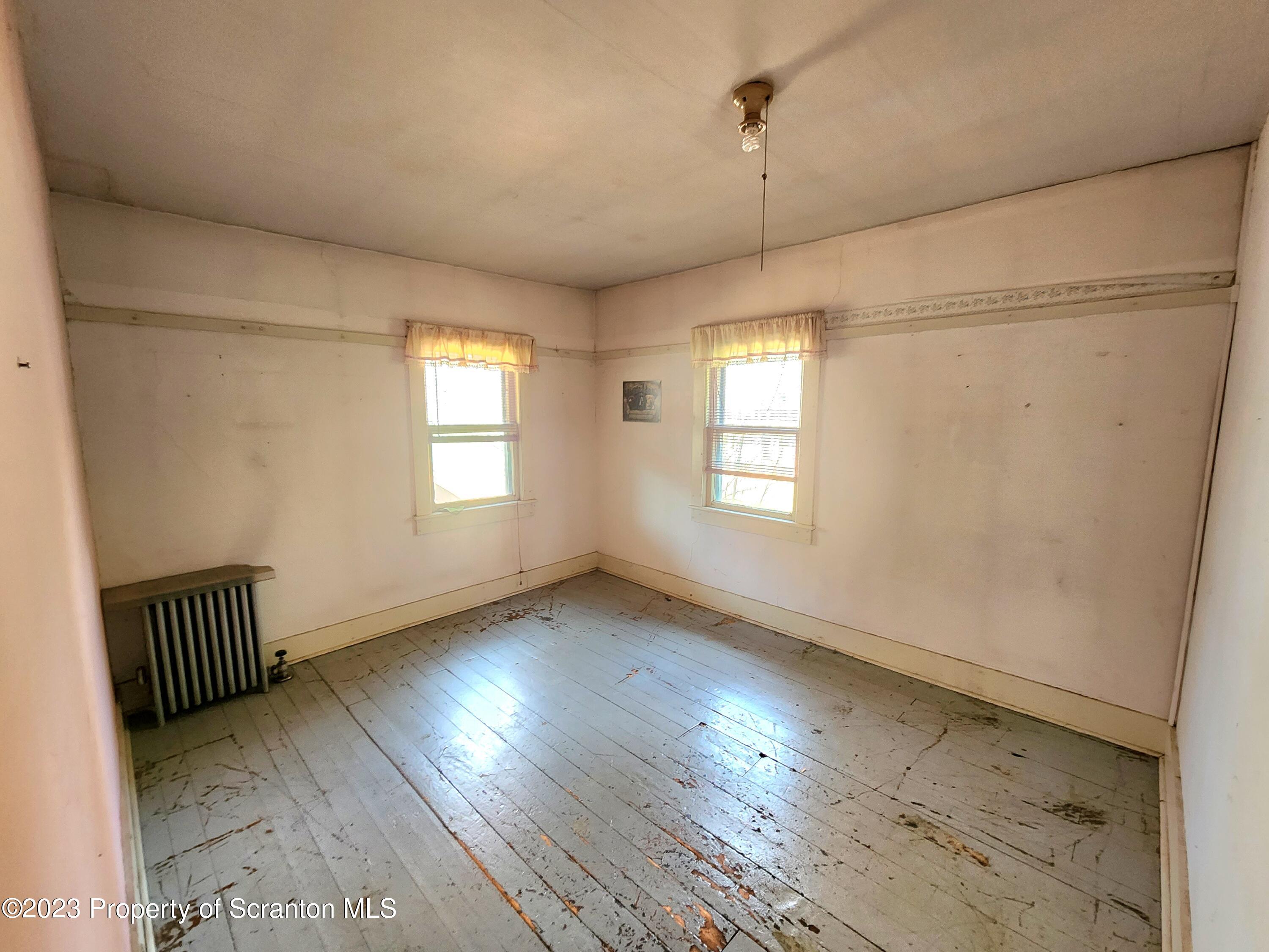 21 High Street Nicholson, PA 18446 - Photo 24 of 33 a view of an empty room with wooden floor and a window