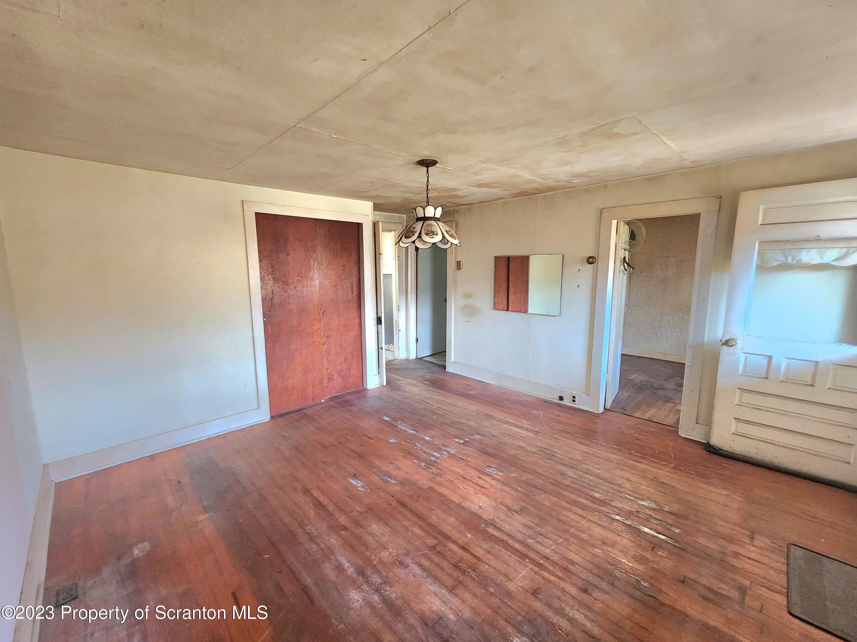 21 High Street Nicholson, PA 18446 - Photo 3 of 33 a view of a livingroom with wooden floor and a ceiling fan