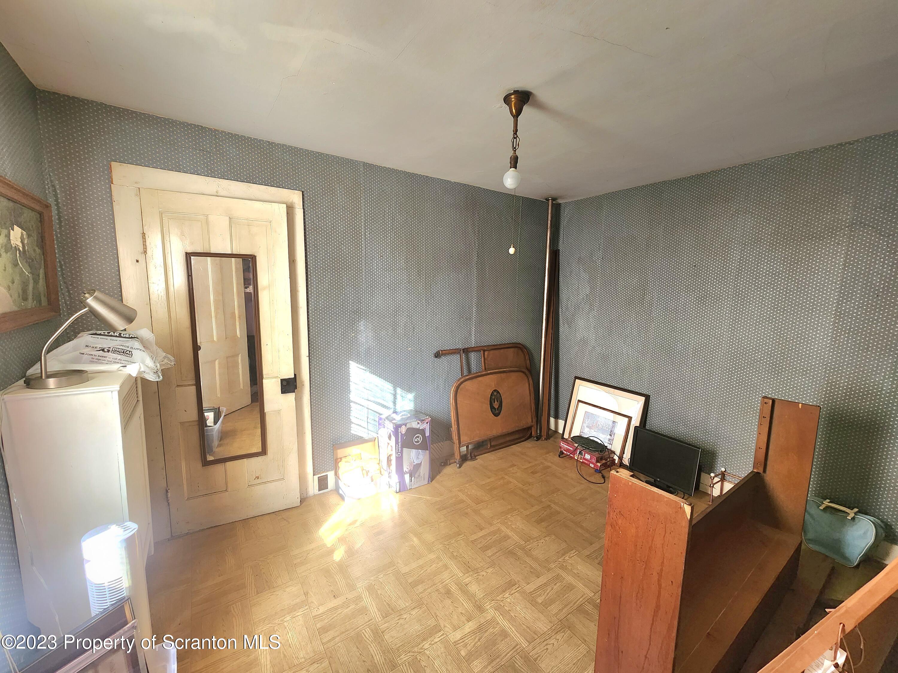21 High Street Nicholson, PA 18446 - Photo 6 of 33 a bedroom with a bed and wooden floor