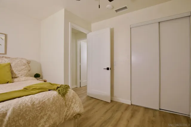 a bedroom with a bed and a dresser