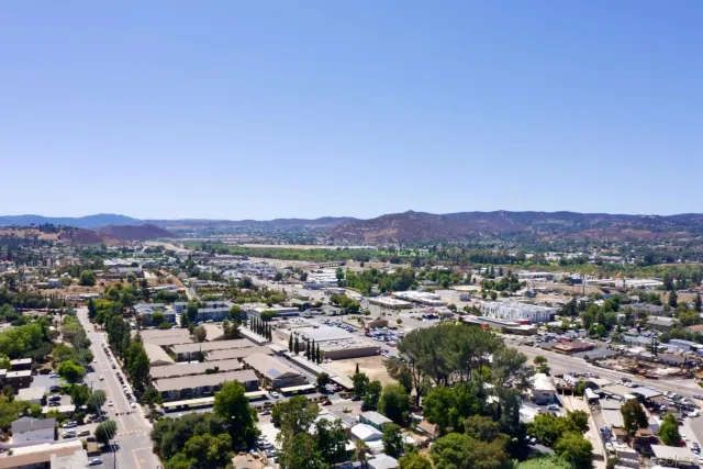 an aerial view of mountain with residential trees