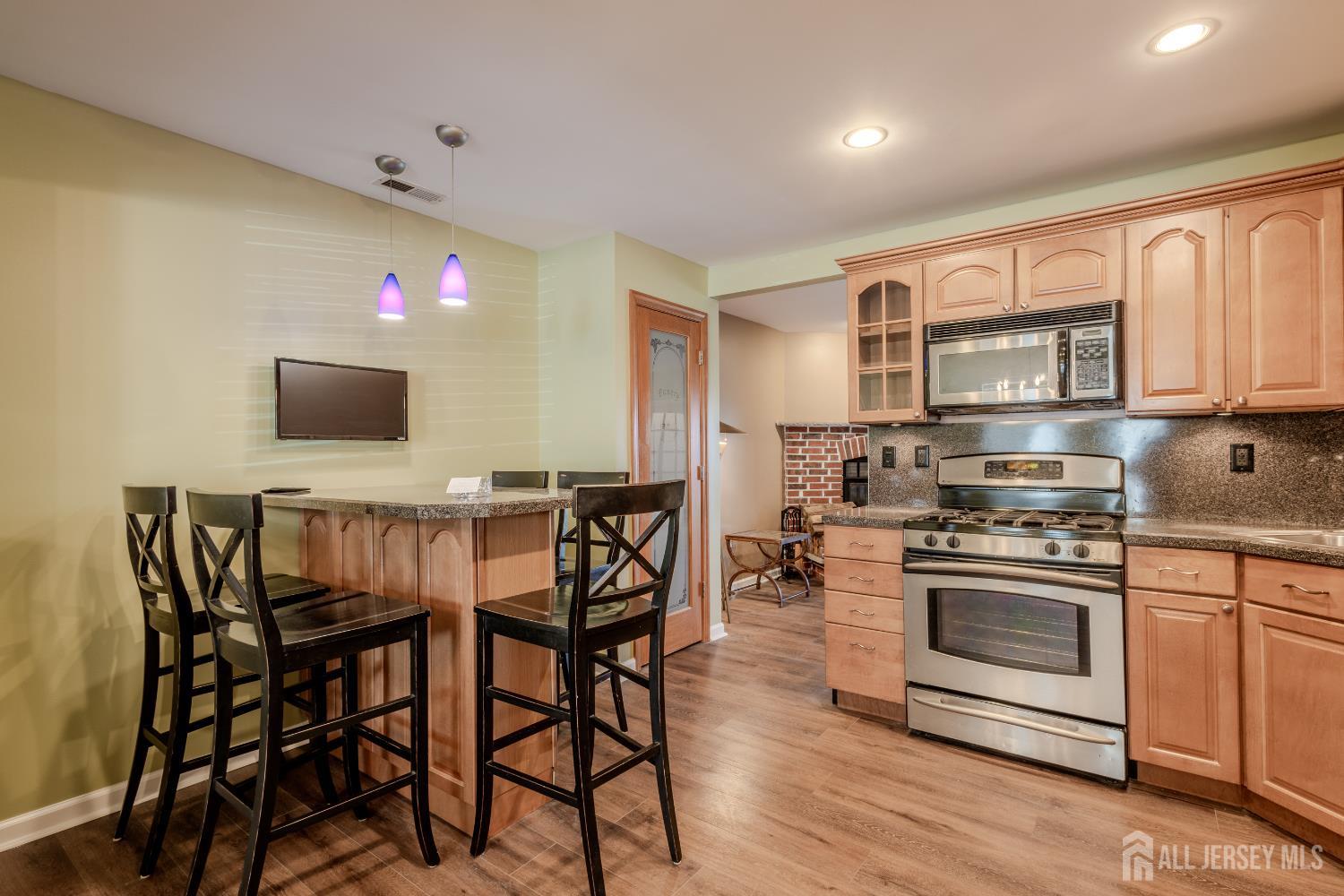 334 Constitution Circle North Brunswick, NJ 08902 - Photo 12 of 42 a kitchen with stainless steel appliances a stove a sink island and a refrigerator