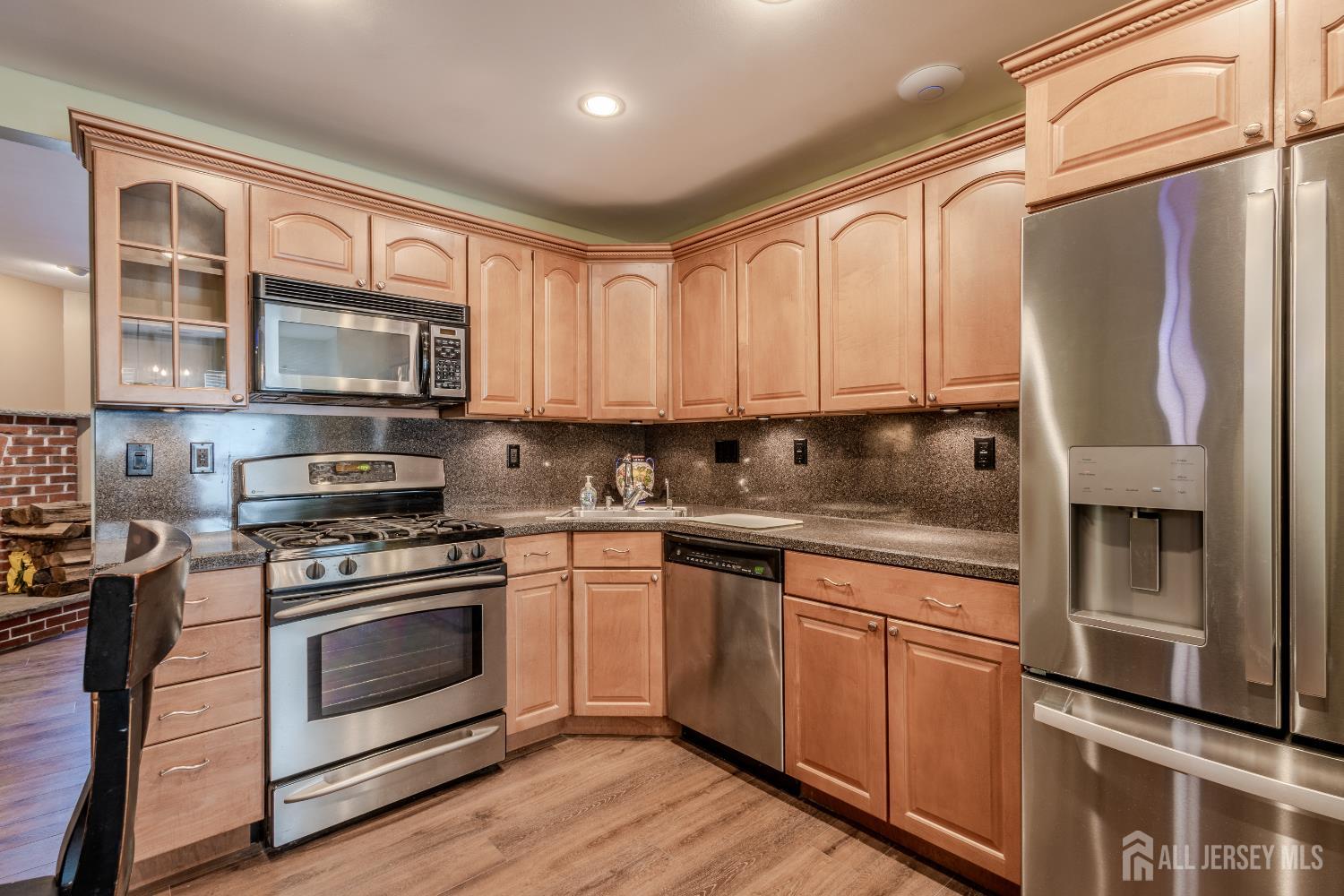 334 Constitution Circle North Brunswick, NJ 08902 - Photo 13 of 42 a kitchen with stainless steel appliances granite countertop a stove a sink and a refrigerator