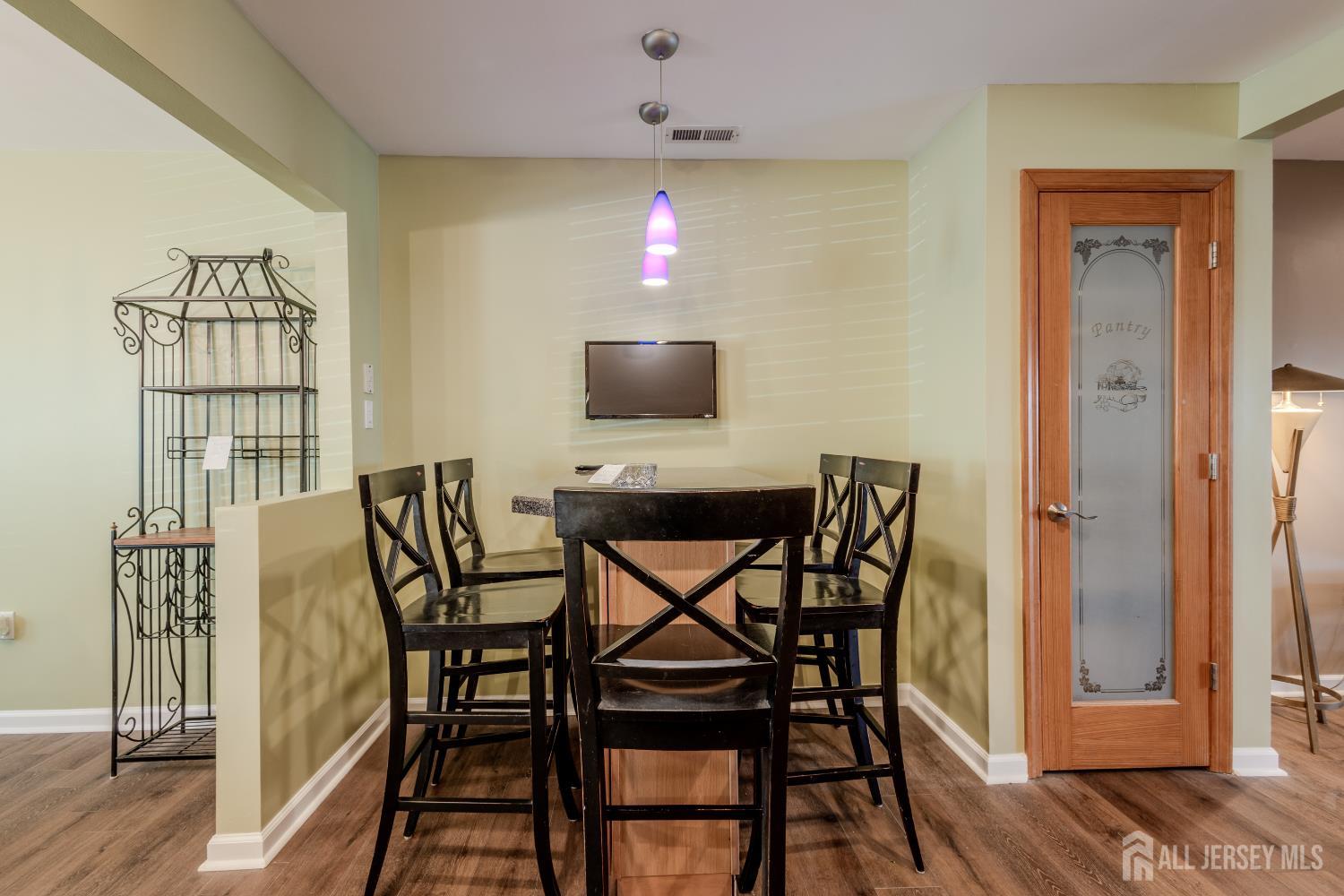 334 Constitution Circle North Brunswick, NJ 08902 - Photo 16 of 42 a view of a dining room with furniture and wooden floor