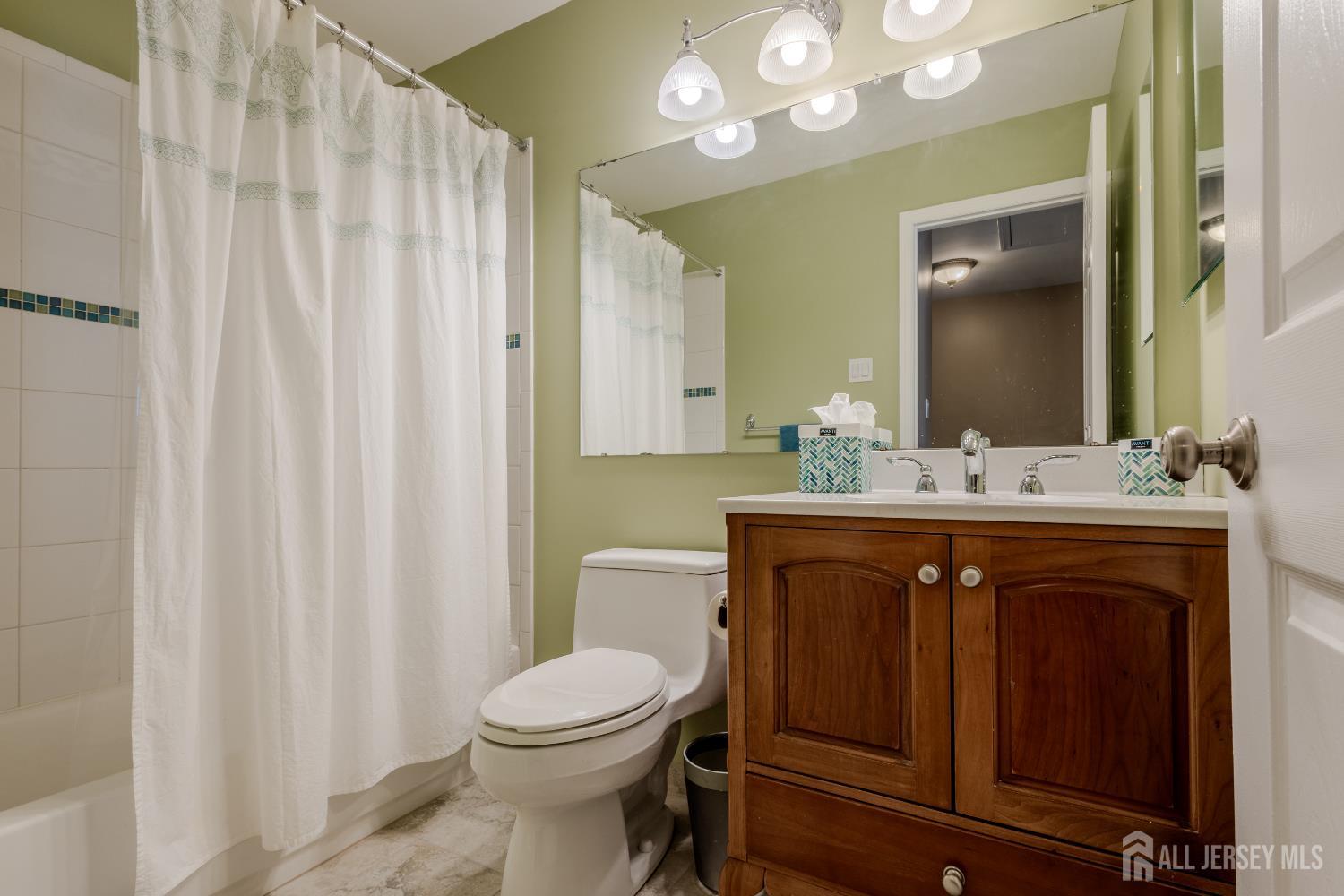 334 Constitution Circle North Brunswick, NJ 08902 - Photo 28 of 42 a bathroom with a sink a toilet and a mirror