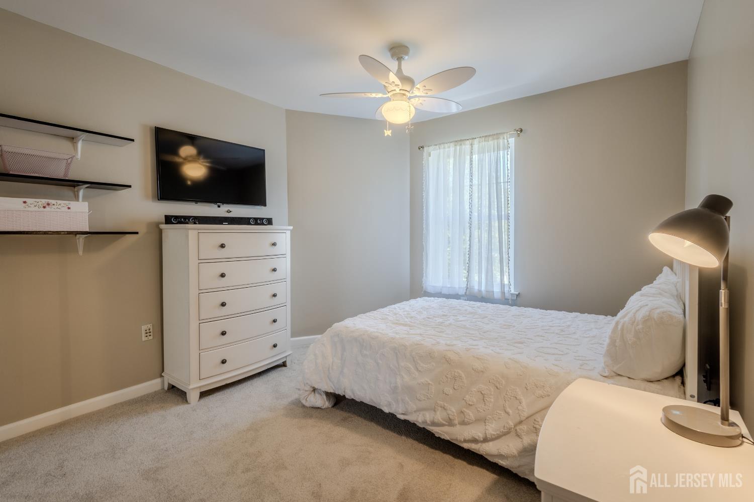 334 Constitution Circle North Brunswick, NJ 08902 - Photo 29 of 42 a bedroom with a bed and a flat screen tv