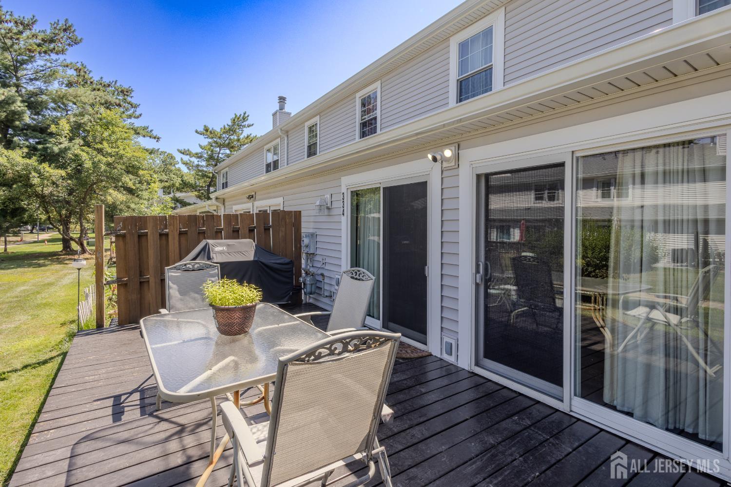 334 Constitution Circle North Brunswick, NJ 08902 - Photo 33 of 42 a view of a patio with table and chairs and potted plants