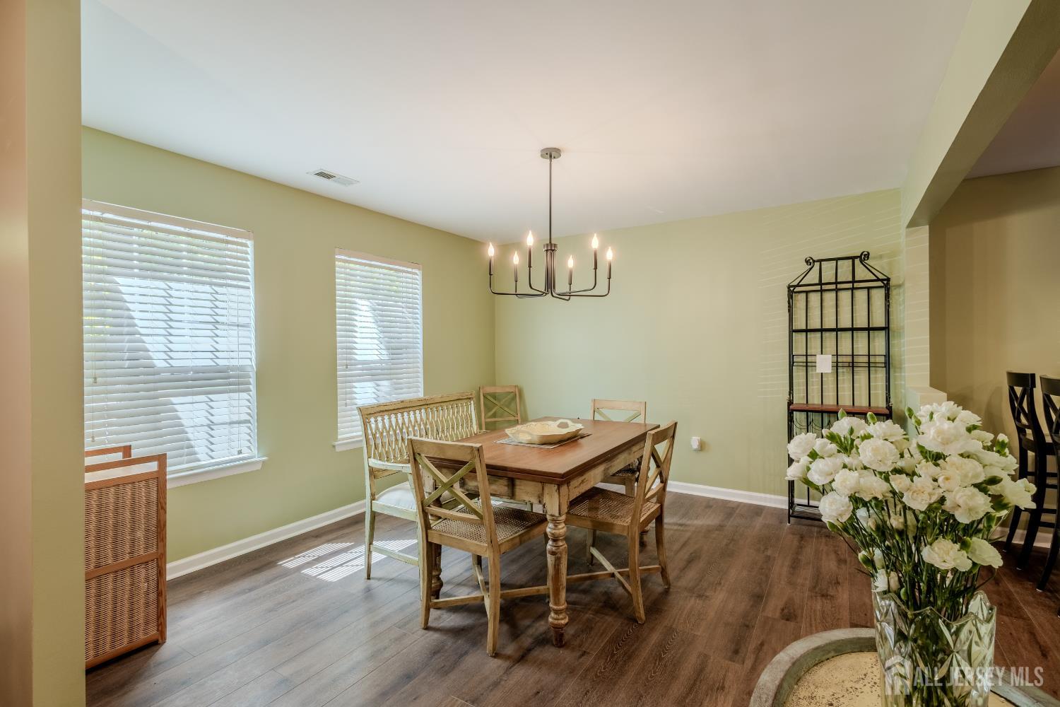 334 Constitution Circle North Brunswick, NJ 08902 - Photo 7 of 42 a view of a dining room with furniture window and wooden floor