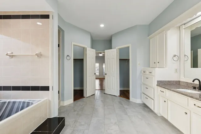 a spacious bathroom with a double vanity sink and a shower