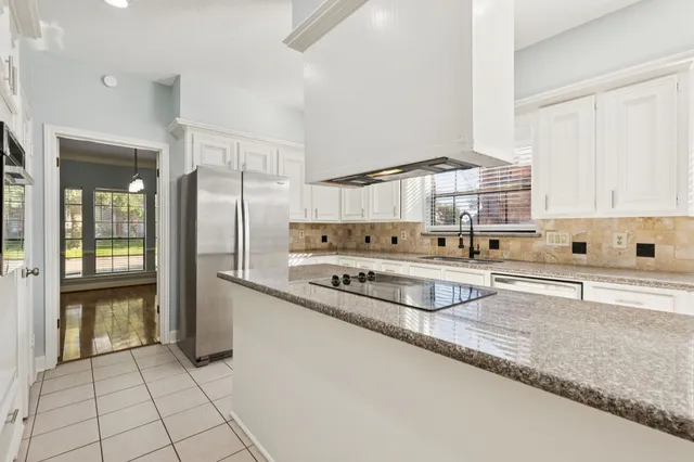 a kitchen with stainless steel appliances granite countertop a sink and cabinets
