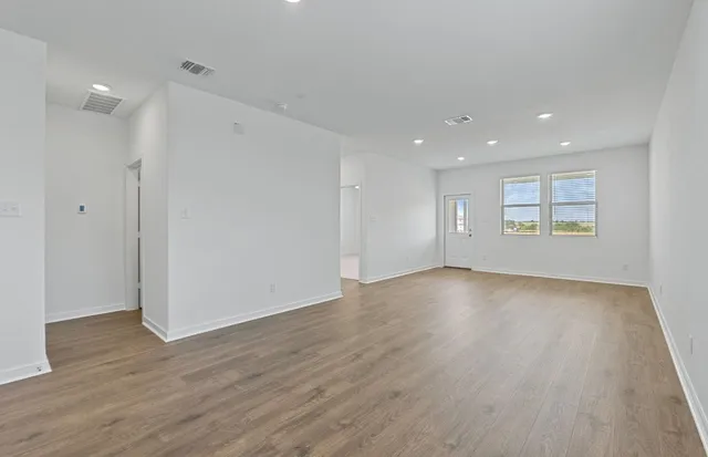 a kitchen with stainless steel appliances granite countertop a sink and a refrigerator