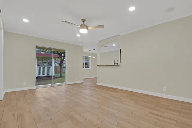 wooden floor in an empty room with a window