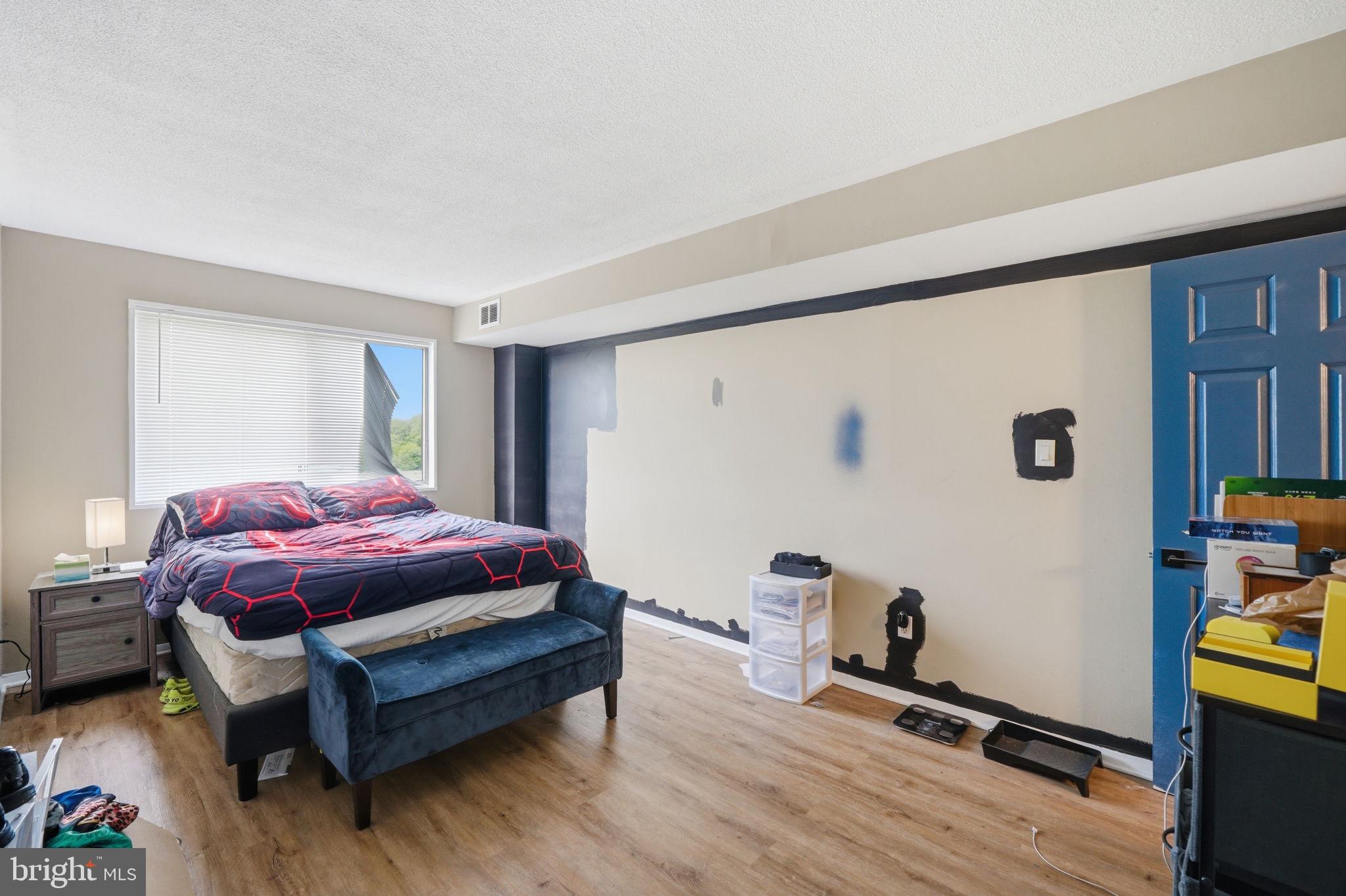 1836 Metzerott Road, Unit 904 Hyattsville, MD 20783 - Photo 11 of 37 a spacious bedroom with a bed and a wooden floor
