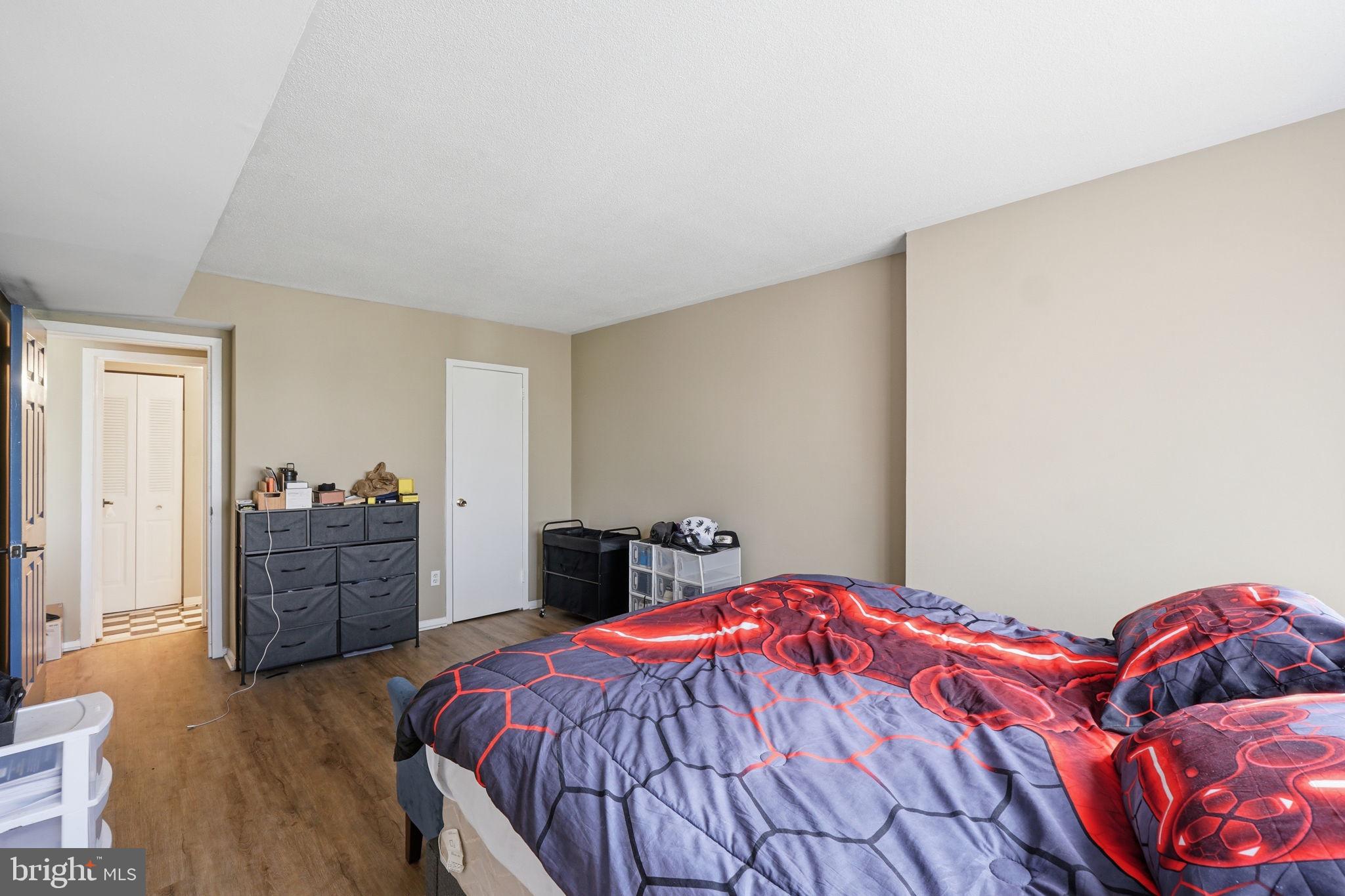 1836 Metzerott Road, Unit 904 Hyattsville, MD 20783 - Photo 12 of 37 a bedroom with a bed and a dresser
