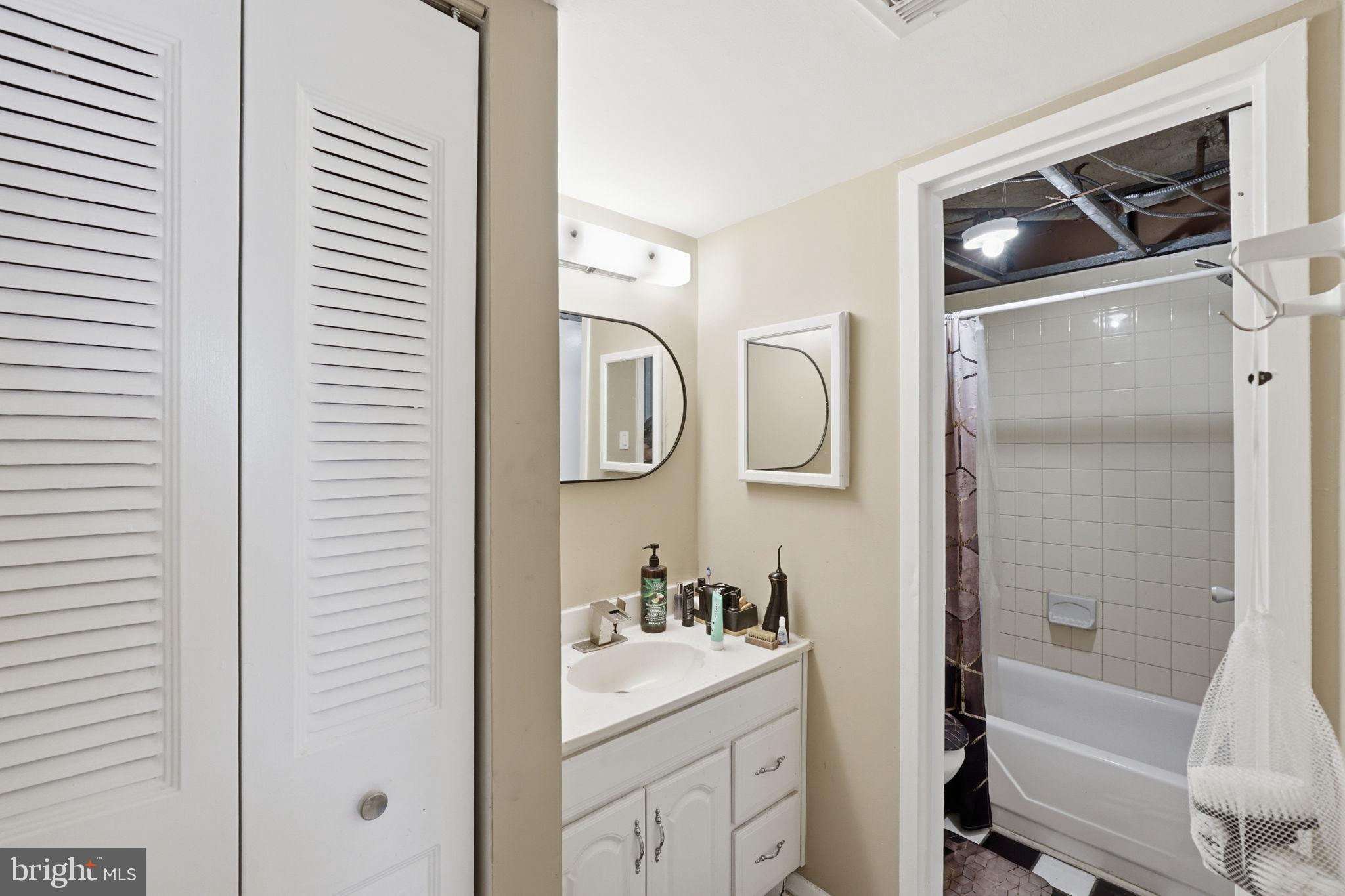 1836 Metzerott Road, Unit 904 Hyattsville, MD 20783 - Photo 17 of 37 a bathroom with a sink a toilet and vanity