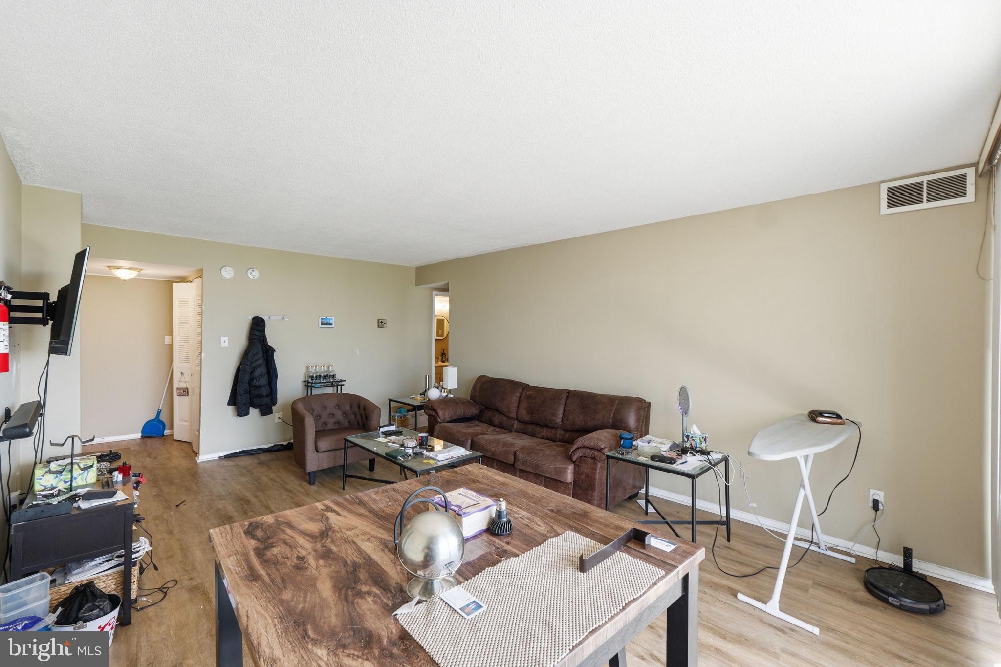 1836 Metzerott Road, Unit 904 Hyattsville, MD 20783 - Photo 3 of 37 a living room with furniture and a wooden floor