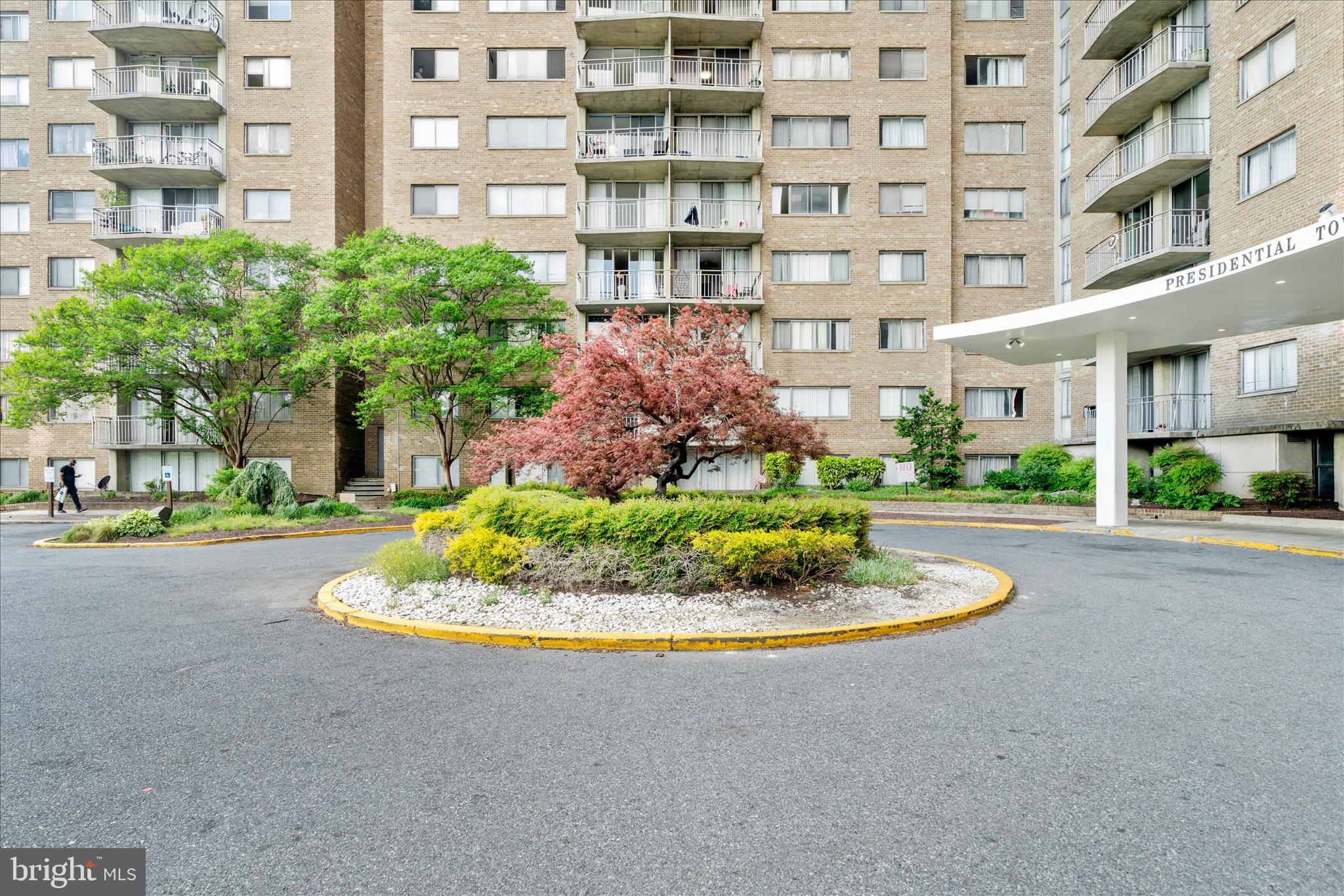 1836 Metzerott Road, Unit 904 Hyattsville, MD 20783 - Photo 32 of 37 a front view of a multi story residential apartment building with yard and outdoor seating