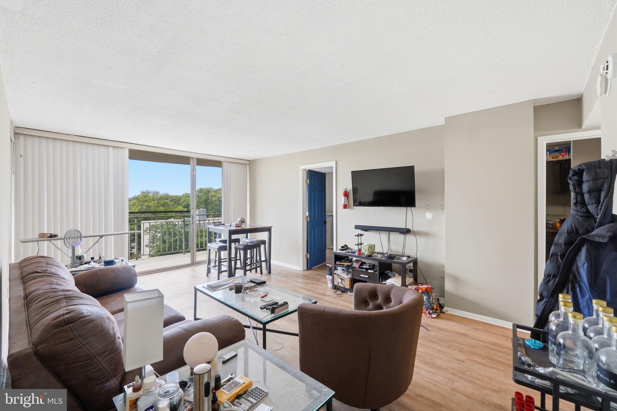 1836 Metzerott Road, Unit 904 Hyattsville, MD 20783 - Photo 5 of 37 a living room with furniture and a flat screen tv