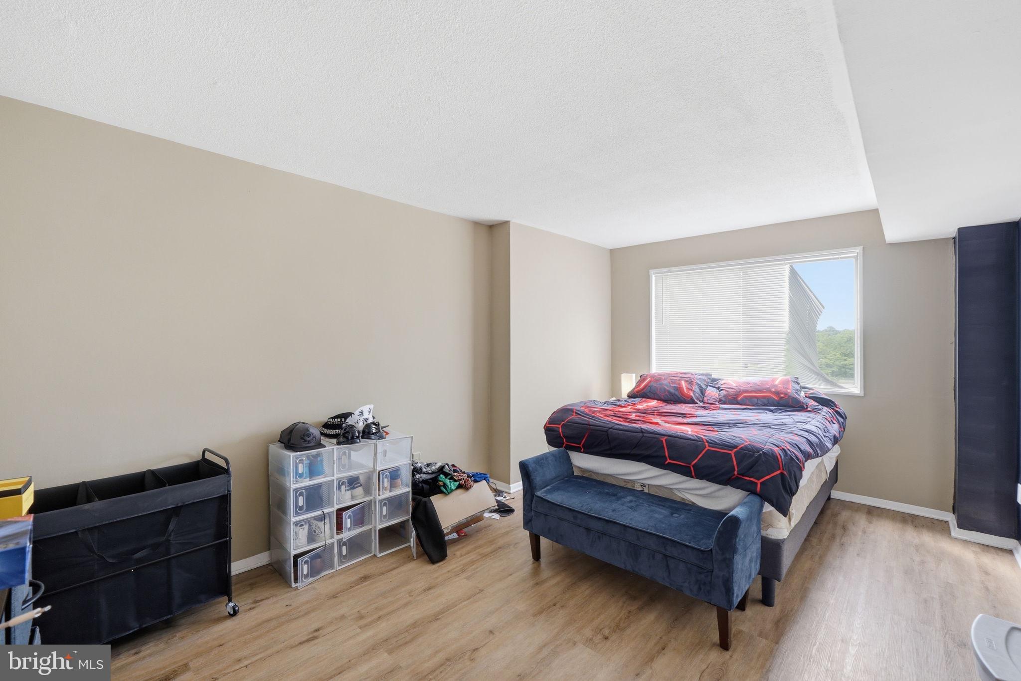 1836 Metzerott Road, Unit 904 Hyattsville, MD 20783 - Photo 10 of 37 a bedroom with a bed and wooden floor