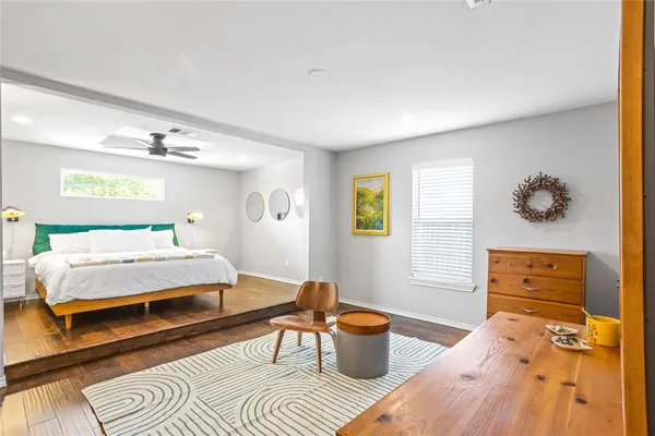 a view of a dining room with furniture a chandelier and wooden floor