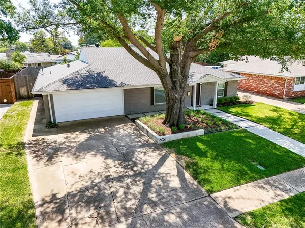 a view of a house with yard and a tree