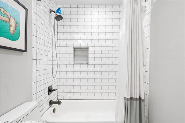 a bathroom with a granite countertop sink a toilet and a mirror
