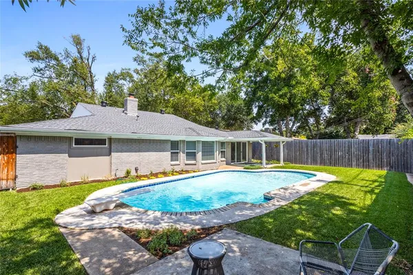 an aerial view of a house with a swimming pool